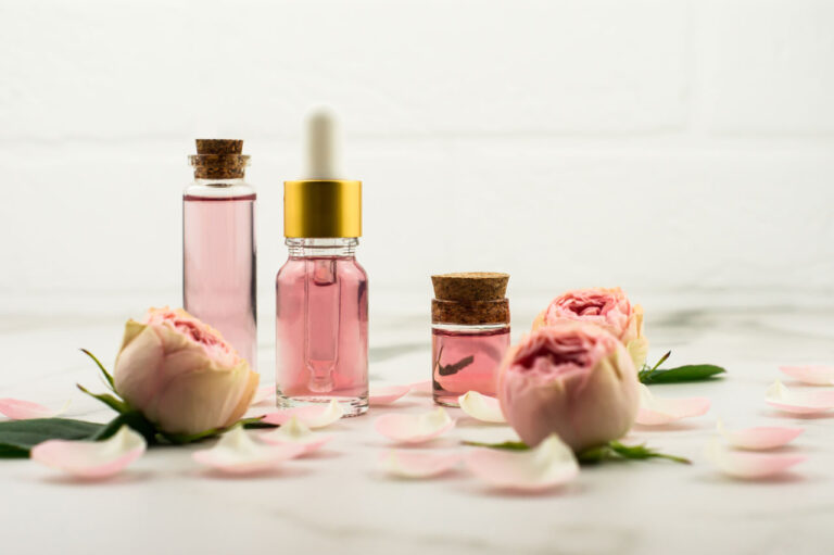 rose-oil-and-rose-water-in-glass-bottles-against-t-2021-11-30-19-53-05-utc